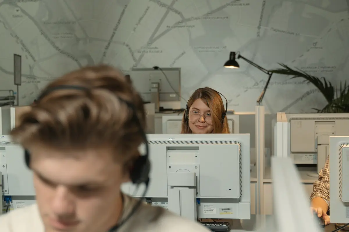 Dispatcher wearing a headset at a computer