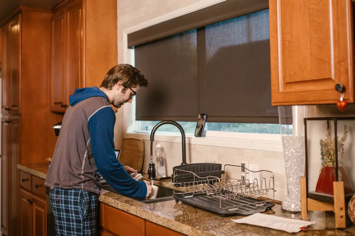 Homeowner washing dishes at his kitchen sink
