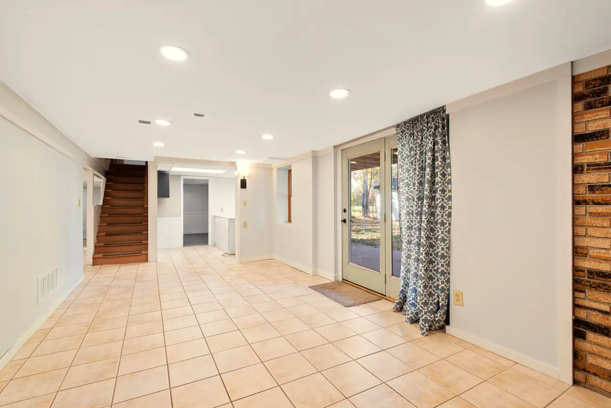 Dry, bright basement with tile floor and glass doors