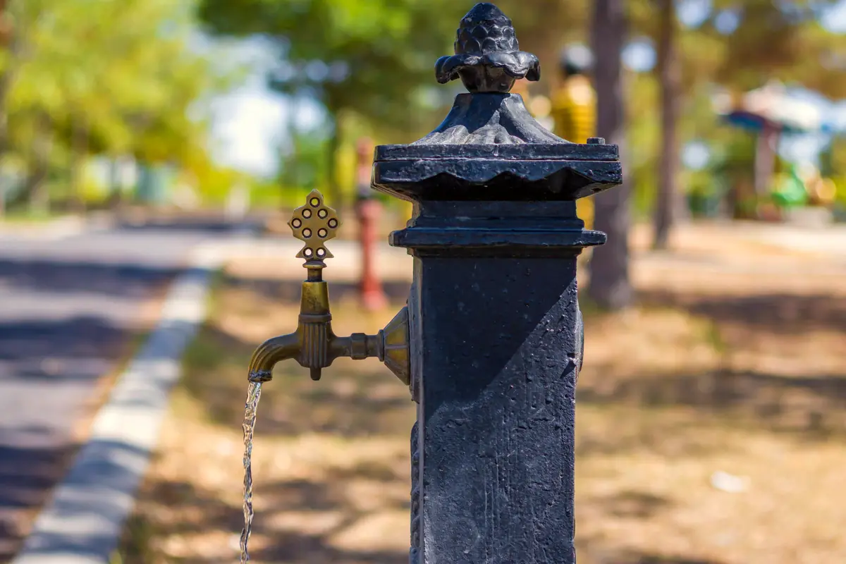 Vintage outdoor water faucet on a sunny day