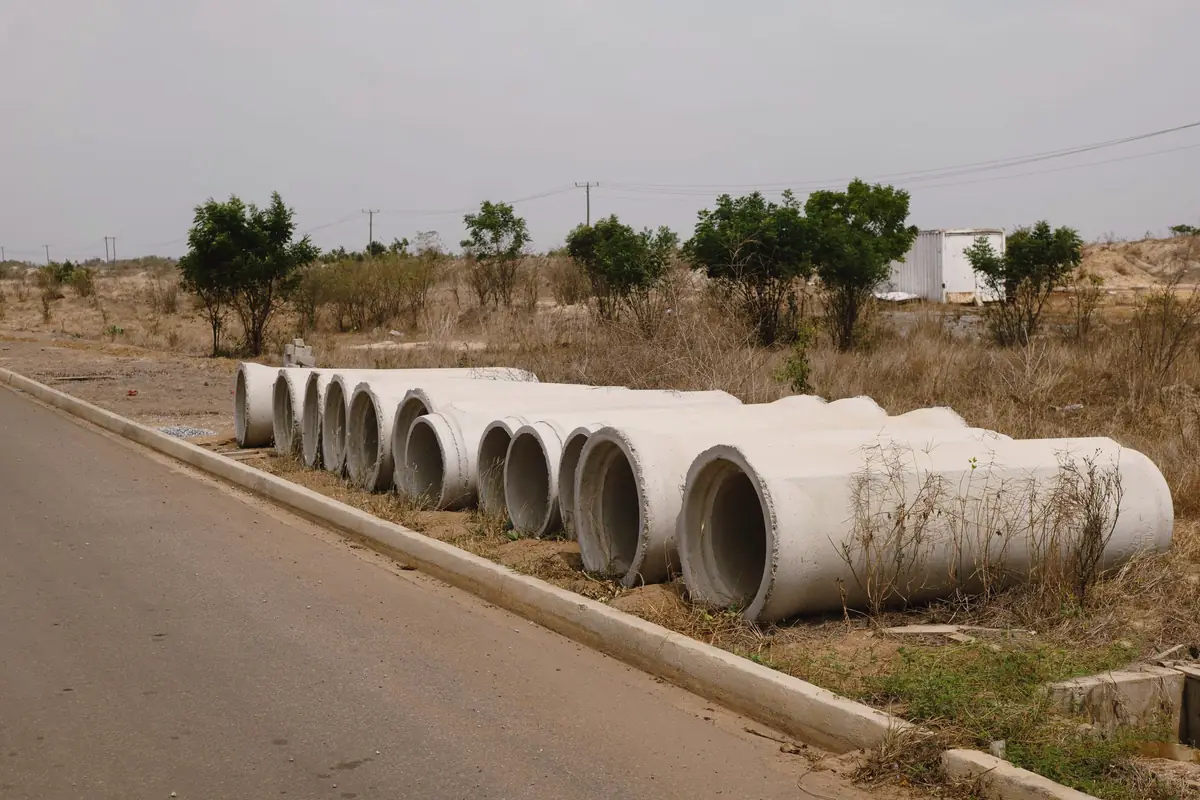 Concrete pipe sections waiting beside a road