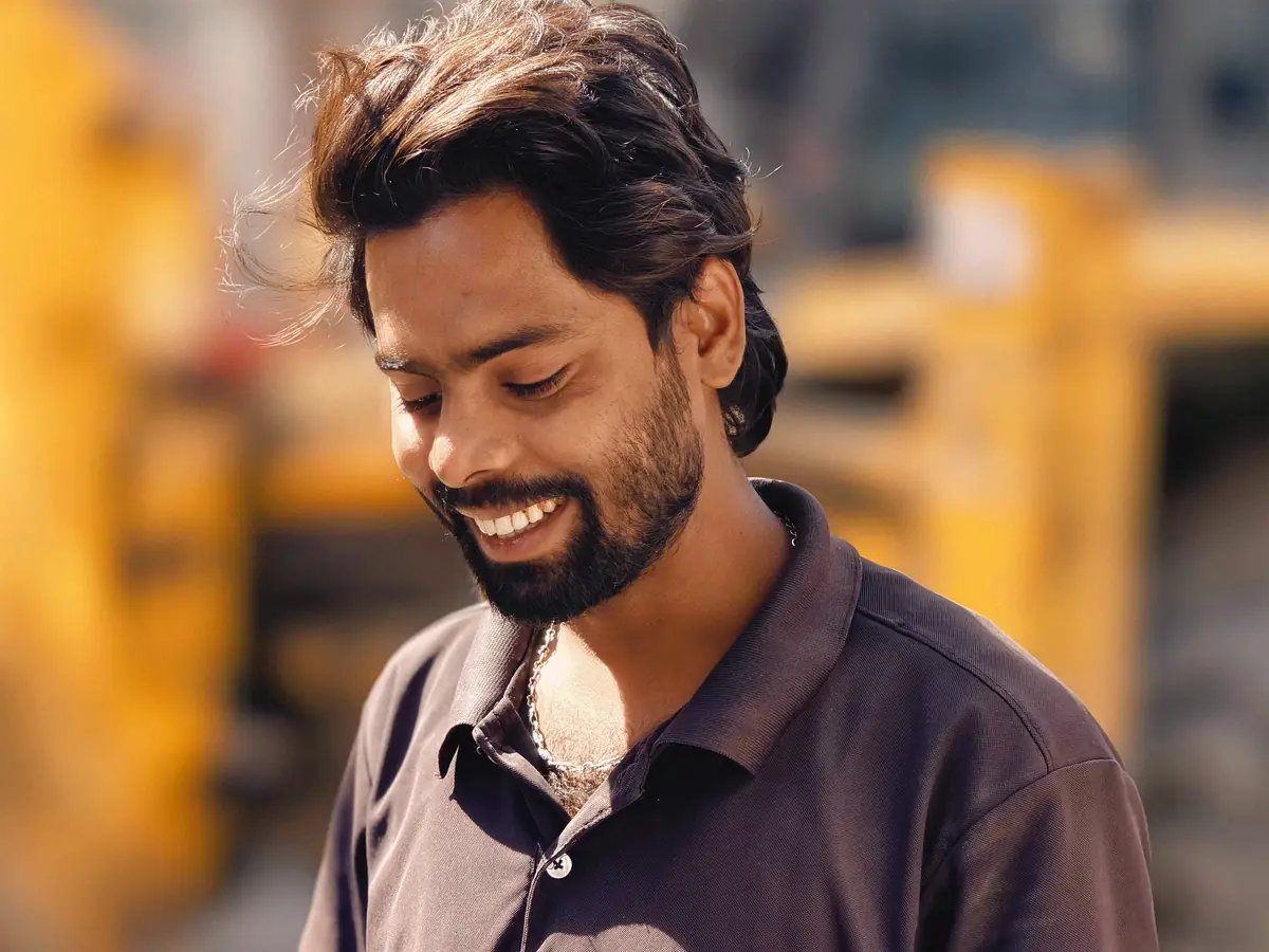 Smiling technician outdoors between calls
