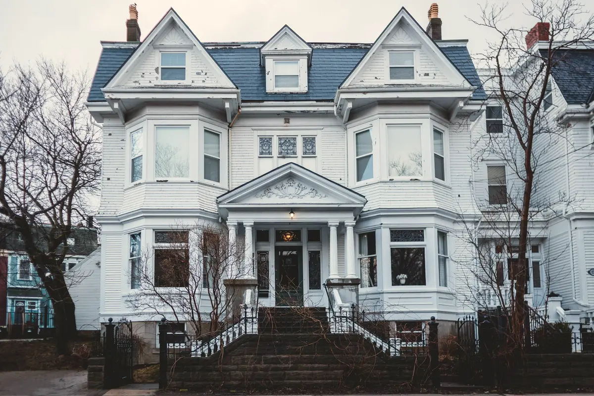 Restored Victorian house with a tall porch and bay windows