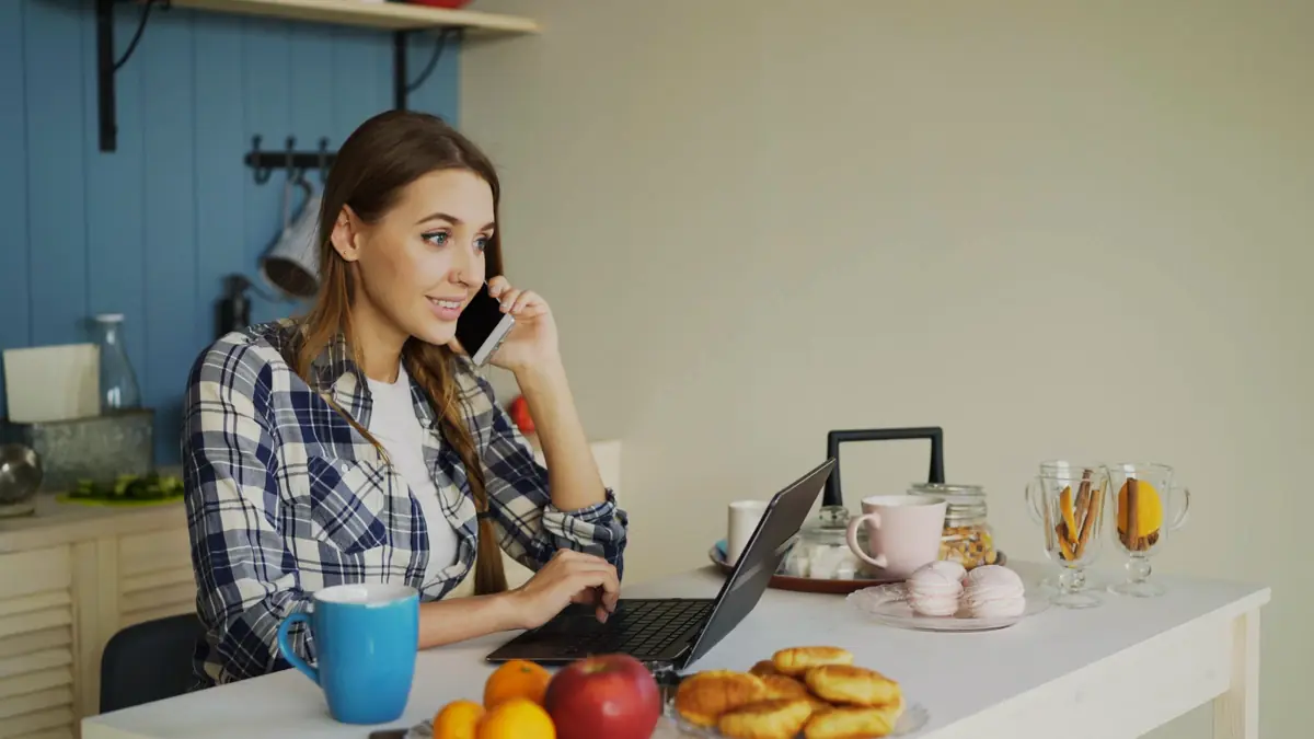 Homeowner on the phone at the kitchen counter